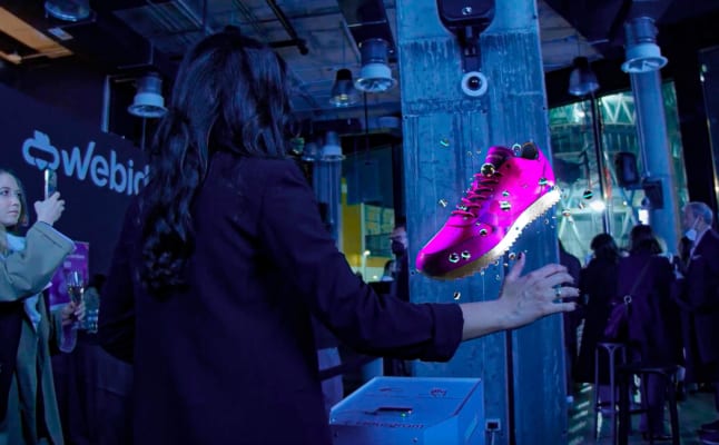 A person holding a pink shoe AI-generated content may be incorrect.