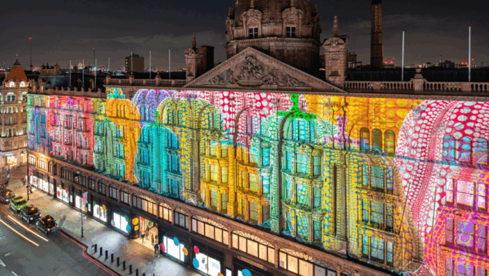 A building with colorful lights on the side AI-generated content may be incorrect.